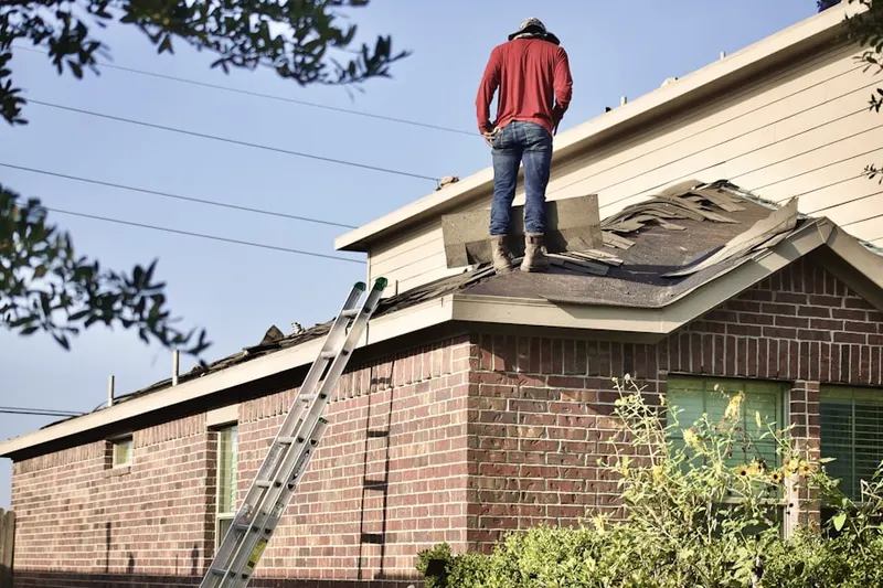 Professional roofer working on a residential roof in Natick